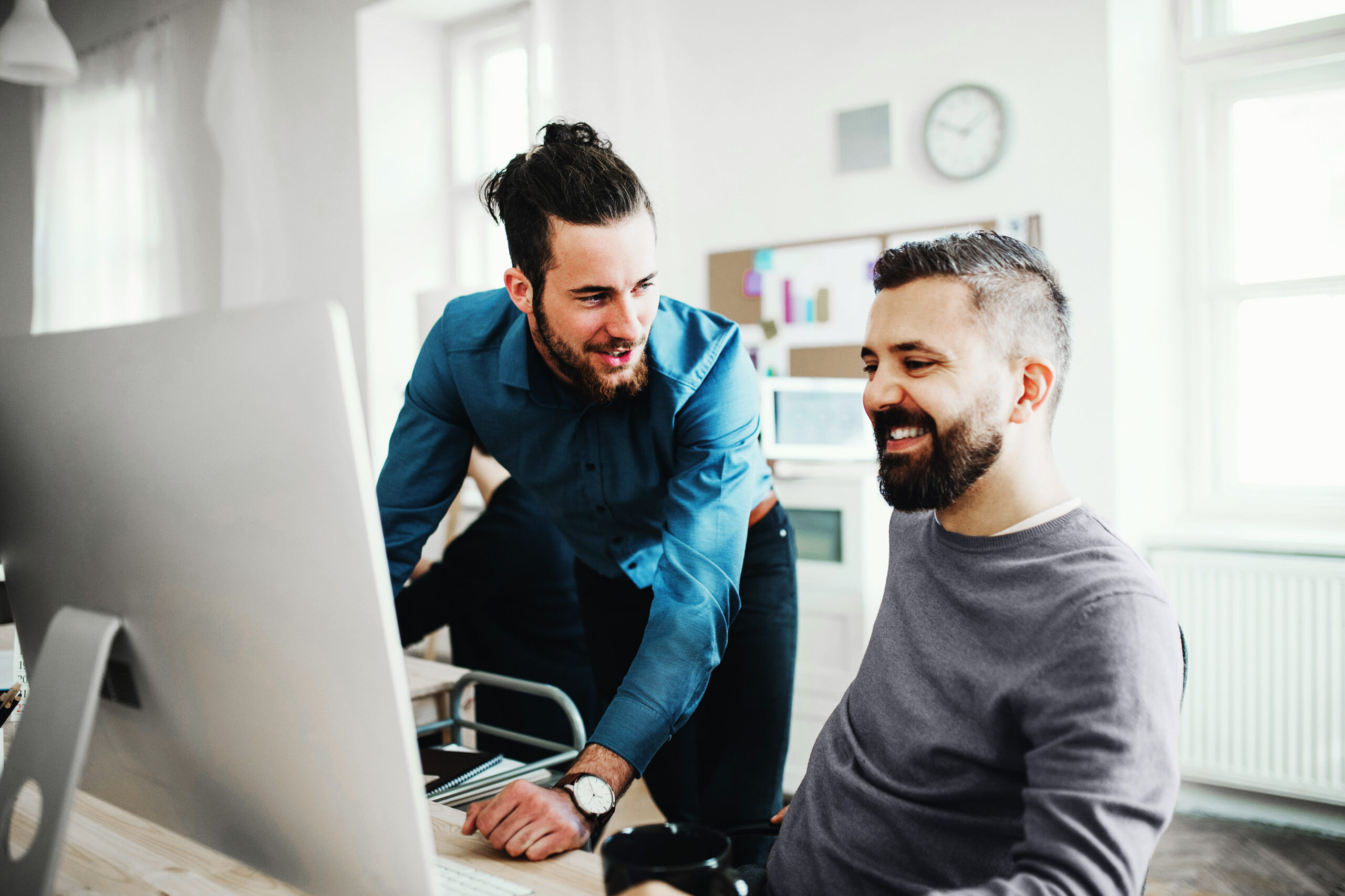 Two colleagues reviewing information at a computer
